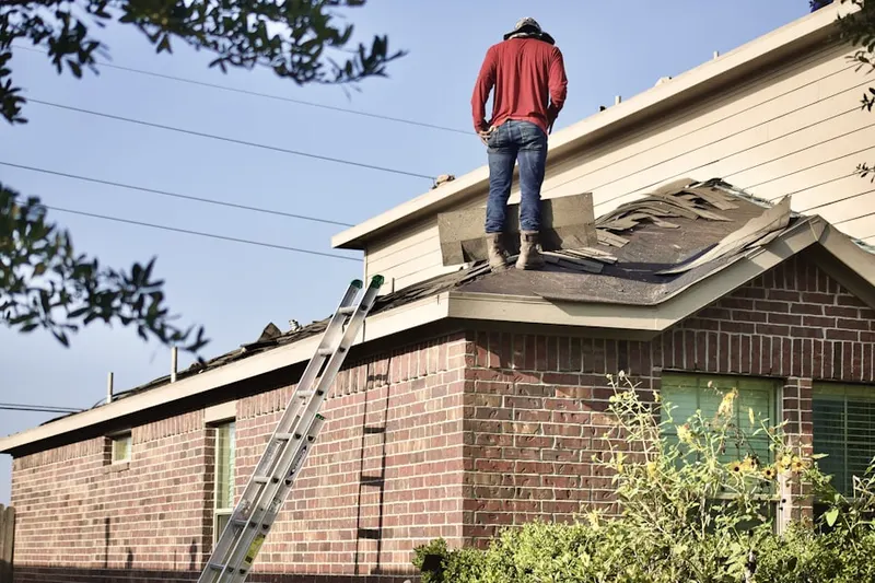 Professional roofer working on a residential roof in Saint George